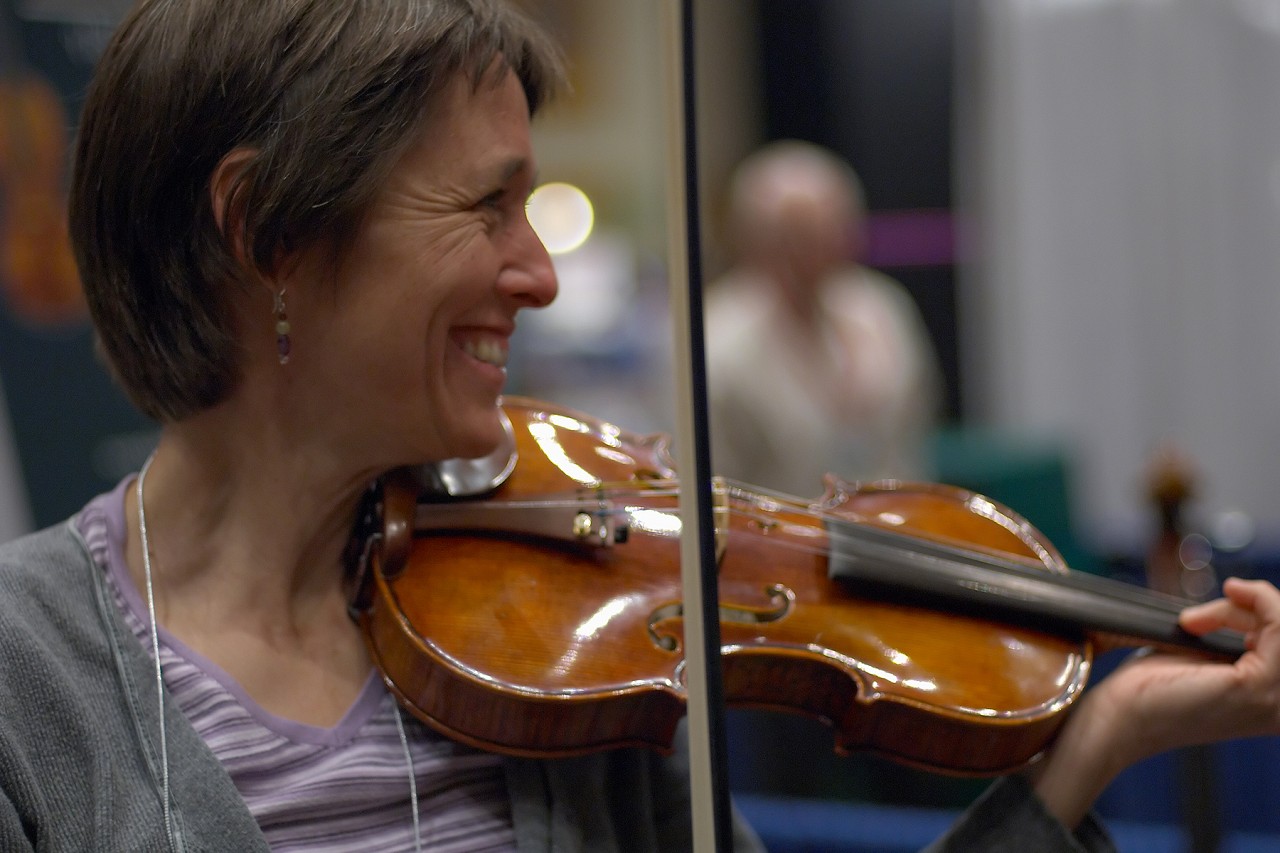 Trying a violin at the 2006 SAA Conference exhibits