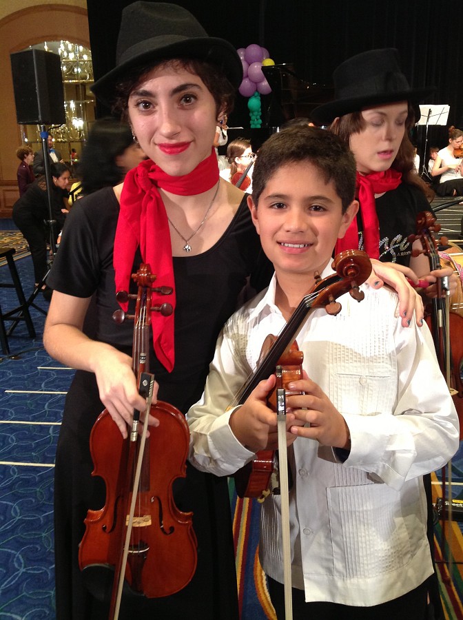 2 students performing with the Latin American Ensemble at the Conference