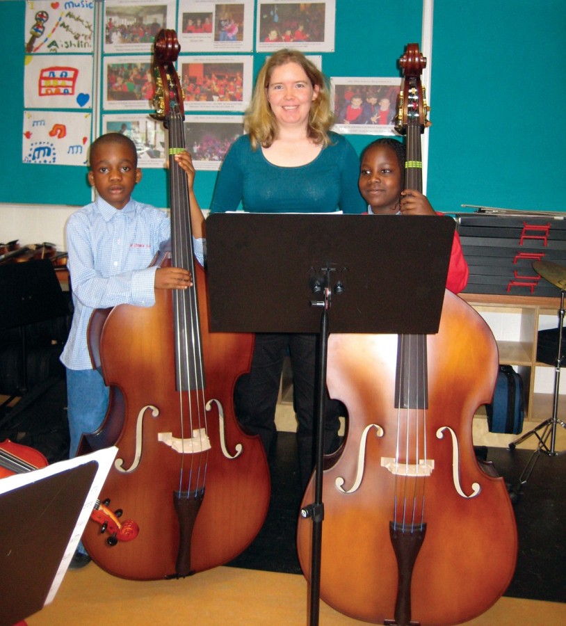 Two beginning bassists from Saint Ultans Cherry orchard with bass teacher Eimear Saunders