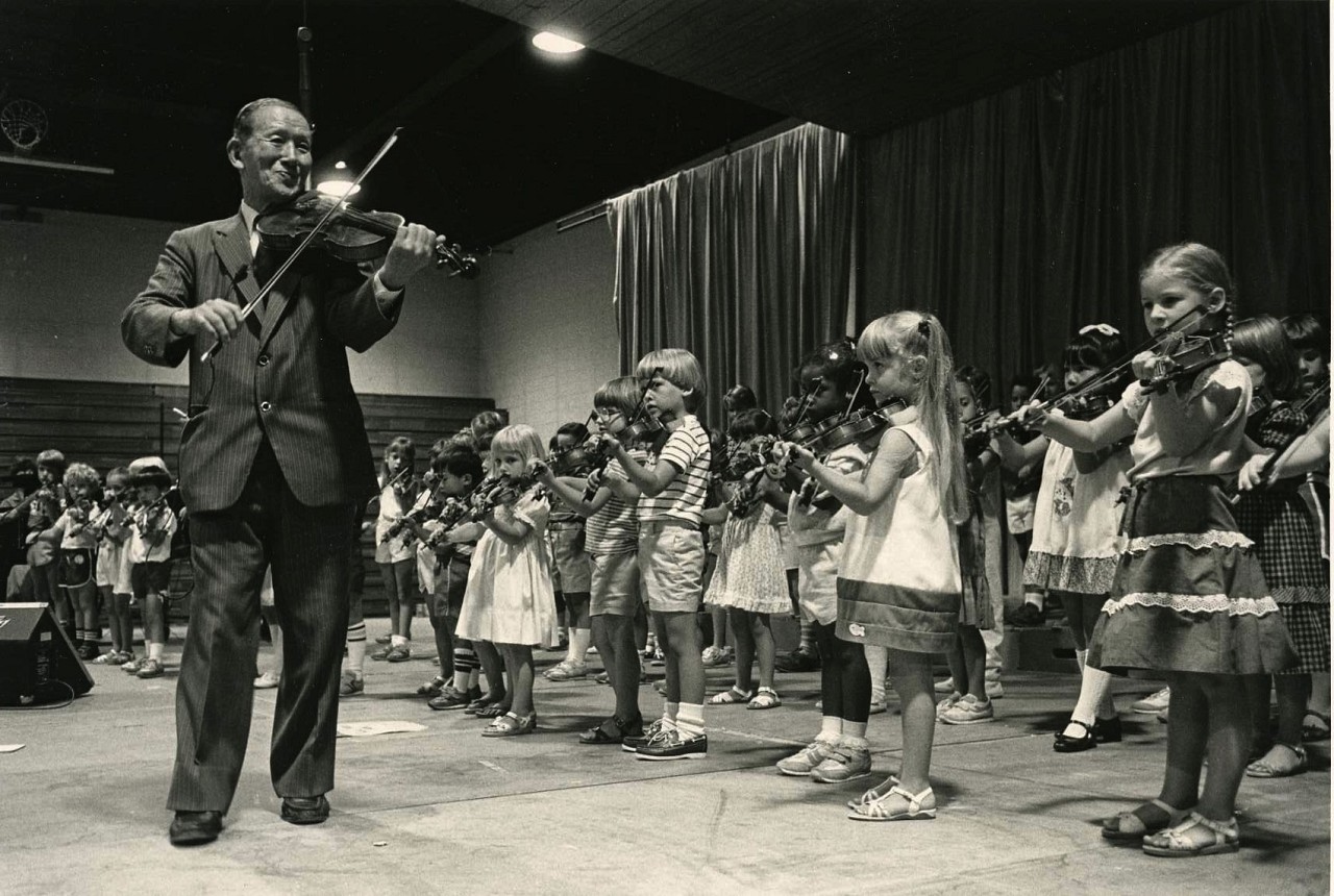 Dr. Shinichi Suzuki Leads a Student Violin Group