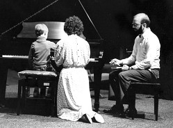 boy and teachers at piano