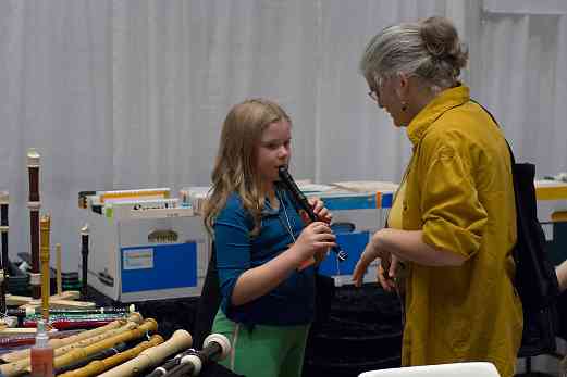 Kathleen Schoen and student try a recorder at the 2006 SAA Conference exhibits