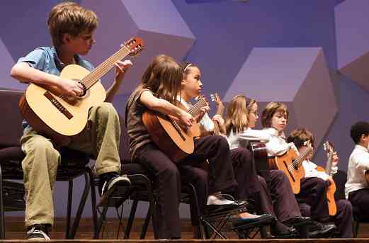 Guitar students perform at the Suzuki Association of Minnesota graduation recital.